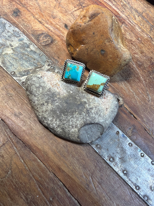 Betty two square Turquoise adjustable rings stamped sterling and by the artist J. And one mini cluster earring, not stamped.
